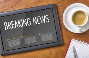 Tablet on a wooden desk - Breaking News